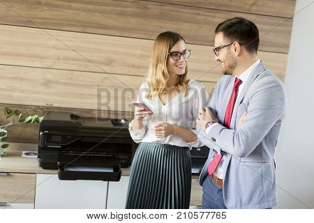 Business People Talking In Office By The Scanner Mashine