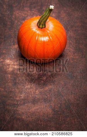 Autumn Pumpkin Thanksgiving Card with orange pumpkin on wooden table with copy space