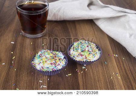 Tasty cupcakes on a white wooden table