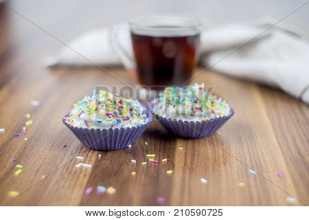 Tasty cupcakes on a white wooden table