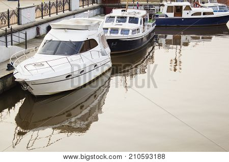 Motor ship at sunset sails on river.