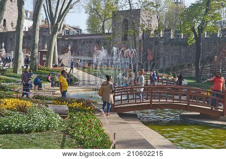 Istanbul Turkey - April 06 2016 Annual Spring Festival of Tulips new design Gulhane Park local people and tourists are getting rest making photos and enjoy good weather and spring slice of life editorial.