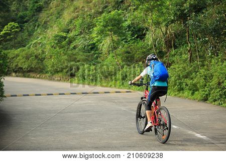 young woman cyclist cycling mountain bike outdoor