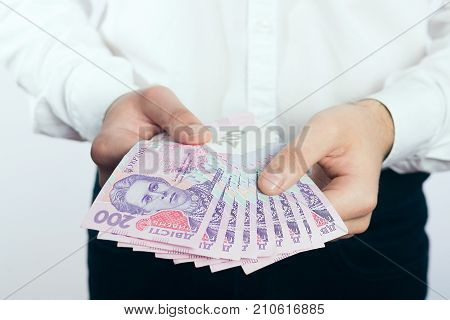 Businessman with hryvnia in his hands UAH