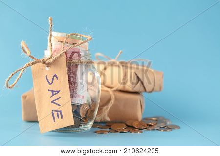 saving money in jar with box of gift