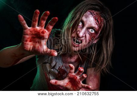 Close-up portrait of horrible zombie woman with wounds. Horror. Halloween poster.The shouting female zombie