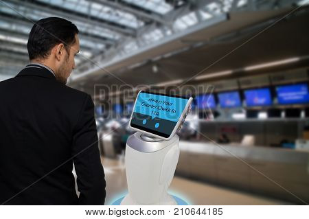 Smart robotic technology concept The passenger follow a service robot to a counter check in in airport the robot can help and give some information to passenger quickly