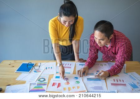 Business consultants is checking and analysis sales figures to plan business strategies.
