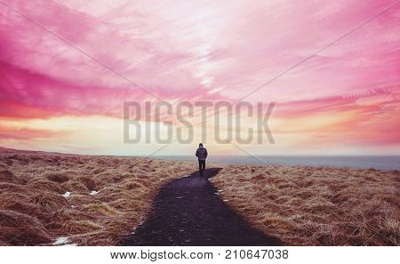 Colorful landscaped, a man walking alone on the way forward with colorful sky