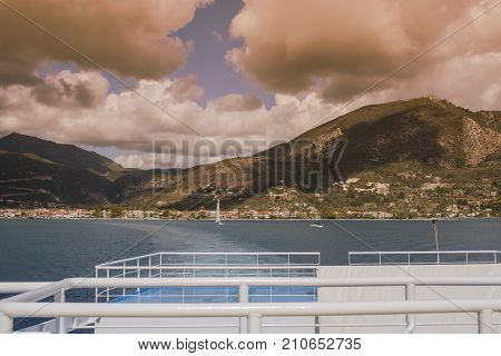 View of the Greek port of Nidri from the ship. Coast of the island of Lefkada at sunset. Greek island Lefkada in the Ionian Sea