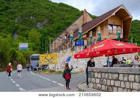 TARA RIVER CANYON MONTENEGRO - SEPTEMBER 12 2017: Unknown tourists are near restaurant at Djurdjevic Bridge Tara River canyon Montenegro