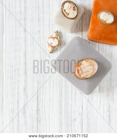 Woman's Jewelry. Vintage jewelry background. Beautiful vintage cameo brooches and jewelry boxes on white background. Flat lay, top view