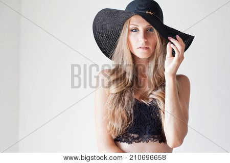 Fashionable Girl In A Hat With A Brim Poses For Advertising