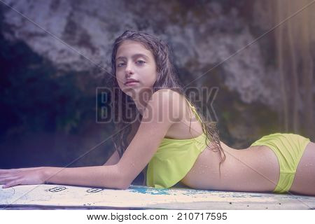 Girl on a surf board relaxed in Cenote sinkhole in  Riviera Maya at mayan Mexico