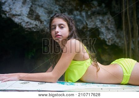 Girl on a surf board relaxed in Cenote sinkhole in  Riviera Maya at mayan Mexico
