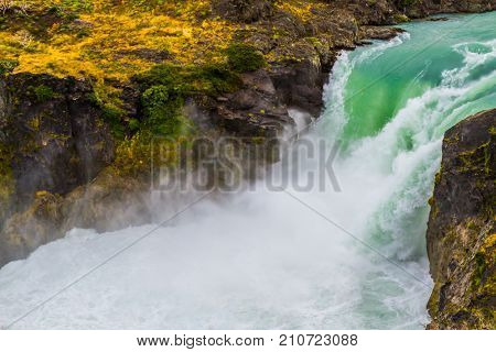 Travel to Patagonia. Southern Province of Chile. Powerful rumbling waterfall Salto Grande. The concept of active and extreme tourism