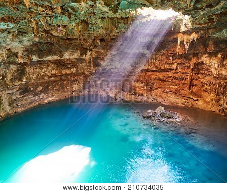 Cenote Samula sinkhole light beam near Valladolid in Yucatan Mexico