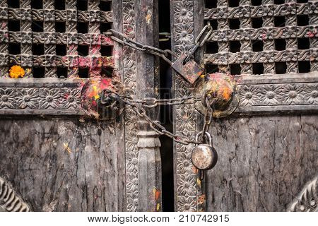 Ttraditional Nepalese wooden door with chain and locks