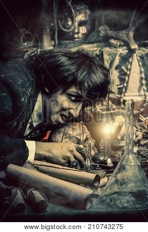 Portrait of a medieval scientist working in his laboratory. Alchemist. Halloween.