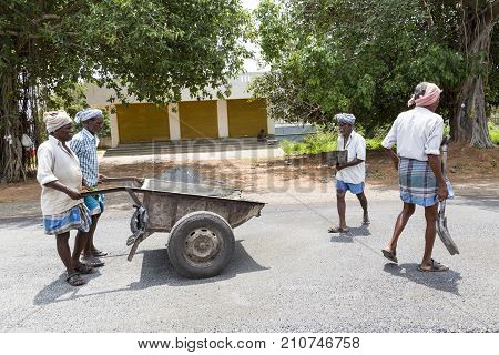 PONDICHERY PUDUCHERY INDIA - SEPTEMBER 05 2017. Unidentified workers works on a road construction industry and teamwork