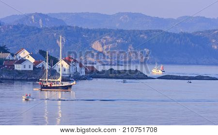KRISTIANSAND ARCHIPELAGO, NORWAY ON JULY 03 View of a sailboat, boats, islands and the fjord on July 03, 2009 in Kristiansand, Norway. Buildings on the cliffs. Editorial use.