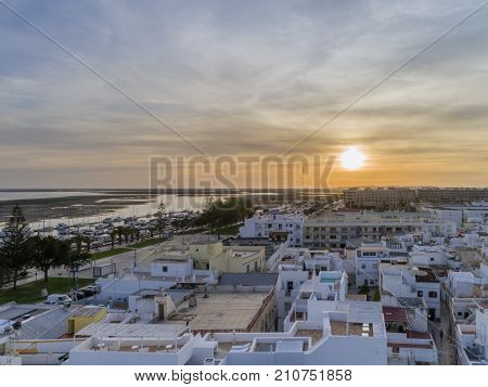 Sunset aerial cityscape in Olhao Algarve fishing village view of ancient neighbourhood of Barreta and its traditional cubist architecture. Portugal.