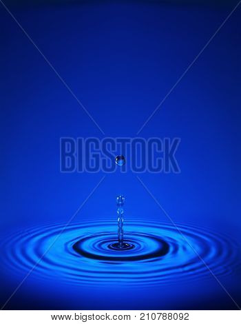 Water Drop With Ripples In Blue Water