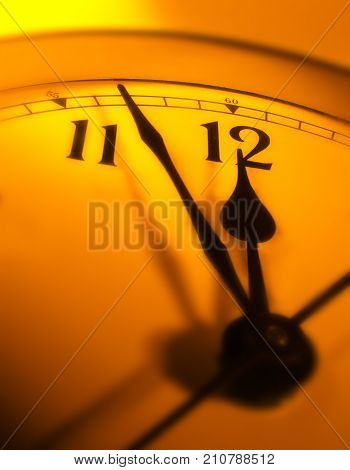 CLOSE UP OF CLOCK FACE WITH HANDS POINTING TOWARDS TWELVE O'CLOCK