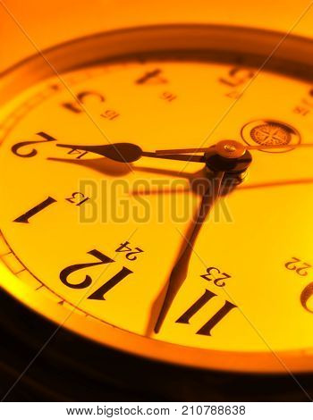 CLOSE UP OF CLOCK FACE WITH HANDS POINTING TOWARDS TWO O'CLOCK