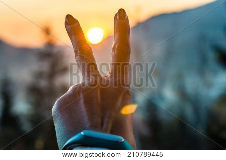 Girl Holding A Compas In A Hand On The Carpathian Mountains Background During The Sunset