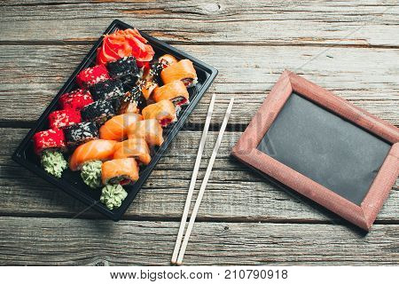 On The Table Are In The Black Container, Sushi Set With Photo Frame