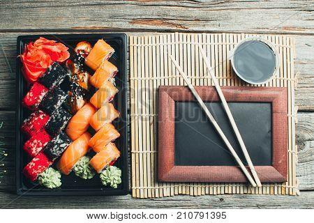 On The Table Are In The Black Container, Sushi Set With Photo Frame