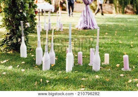 Place for wedding ceremony with white chairs and an arch of living plants