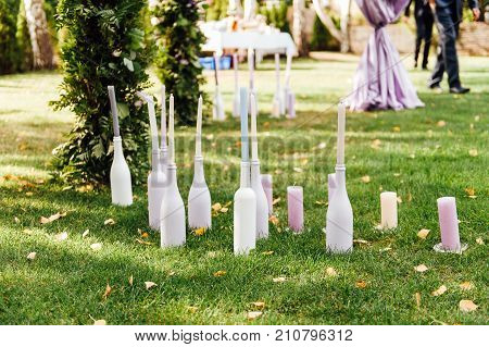 Place for wedding ceremony with white chairs and an arch of living plants