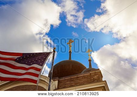 God Bless America American flag church with blue sky and clouds