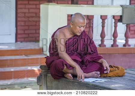 AMARAPURA MYANMAR - SEP 03 : Monk at the Mahagandayon Monastery in Amarapura Myanmaron September 03 2017 Mahagandayon Monastery has 2000 monks at any given time.