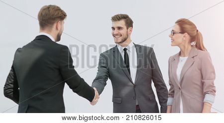 Happy smiling business people shaking hands after a deal in offi