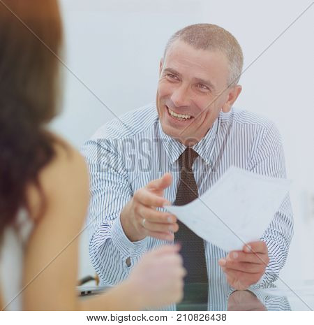 boss discusses with the assistant business documents in the offi