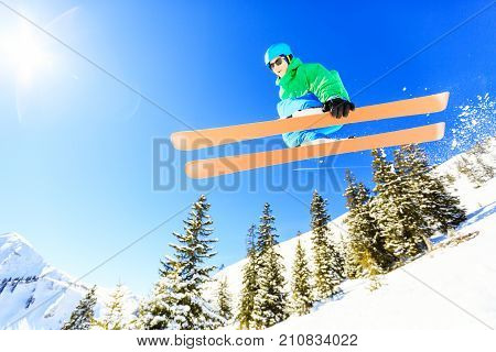 action shot of teenager jumping with his skis