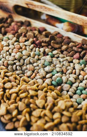Dry pet food for dogs and cats on table.