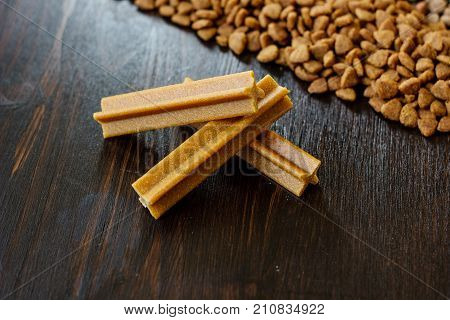 Dry pet food on black wooden table