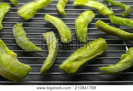 Pieces of green pomelo on the grate for drying side view horizontal