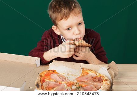 Children Eat Italian Pizza In The Cafe. School Boy Is Eating Pizza For Lunch. Child Unhealthy Meal C