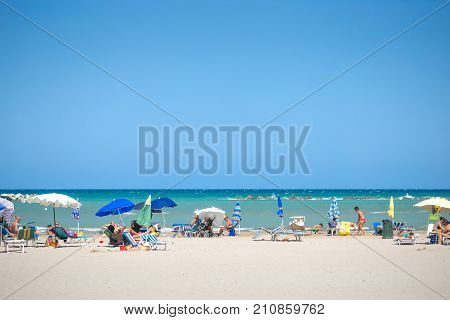 White Beaches Italy. Sea Sky People Umbrellas Sun Beds.