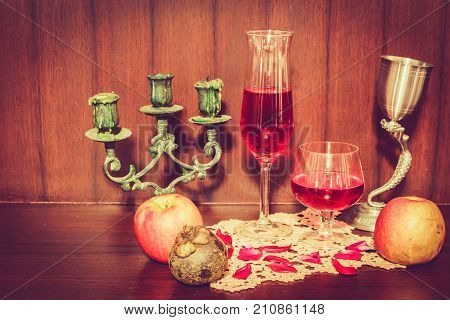 Still Life Image Of Red Wine And Fruits Over Wooden Background