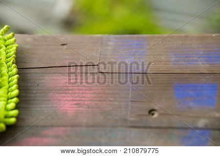 Closeup image new bright fluffy cleaning mop lying on wooden surface