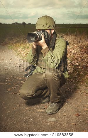 Journalist in war conflict field zone photographing