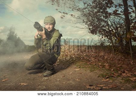 Photographer in war conflict field zone between taking pictures