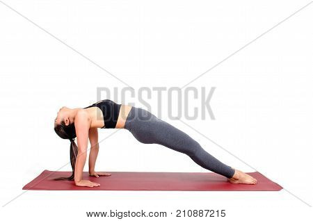 young asian woman doing yoga in Purvottanasana or Upward Plank yoga pose on the mat isolated on white background exercise fitness sport training healthy lifestyle concept