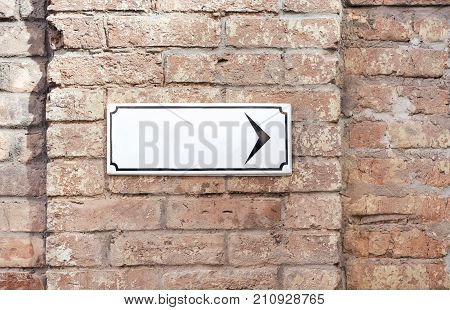 Background old red brick wall pattern texture. sign board blank frame with a black arrow. moke up